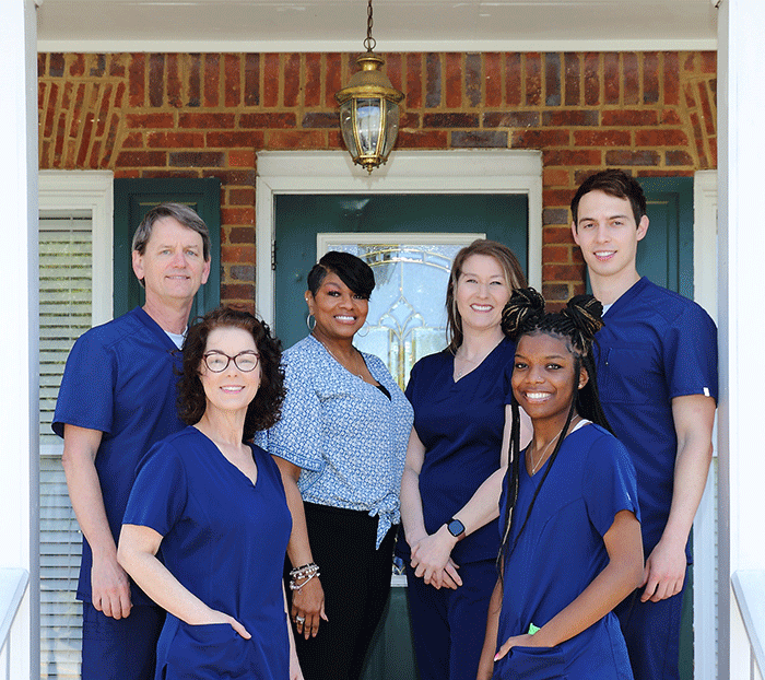 Photo of the Peachtree Corners Dentistry staff on the front steps of the office.